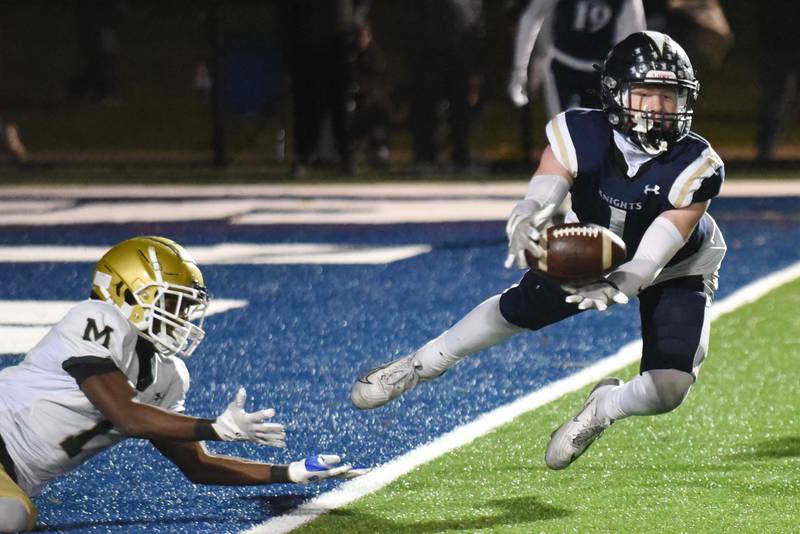 IC Catholic's Will Schmidt, right, attempts to haul in an interception in front of Bishop McNamara's Malachi Lee during an IHSA Class 3A second round playoff game at IC Catholic Friday, Nov. 7, 2025.