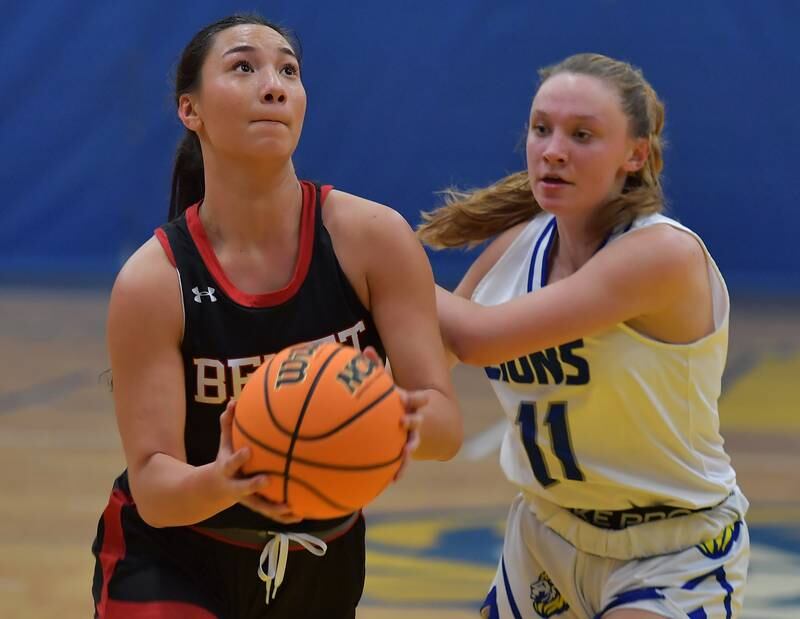 Benet's Emma Briggs goes to the basket as Lyons Township's Tess Bernson (11) defends during a game on November 19, 2024 at Lyons Township High School in LaGrange.