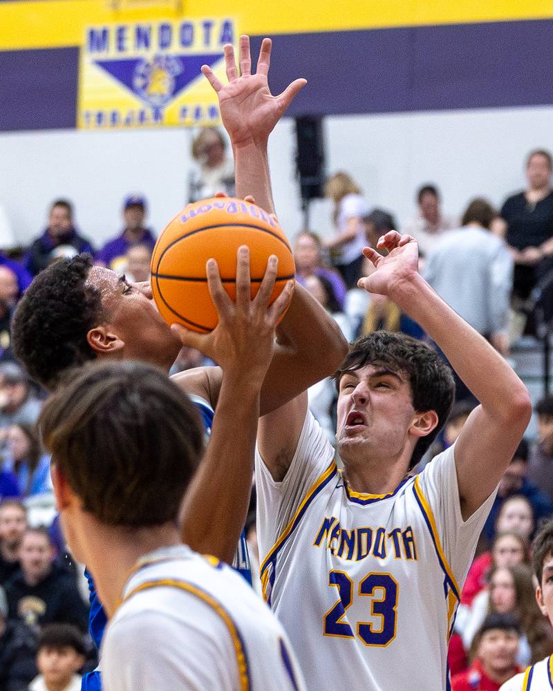Newman's Tyson Williams (1) is met by Dane Doyle (23) of Mendota when going up for layup on Friday, January 30, 2026 at Mendota High School in Mendota.