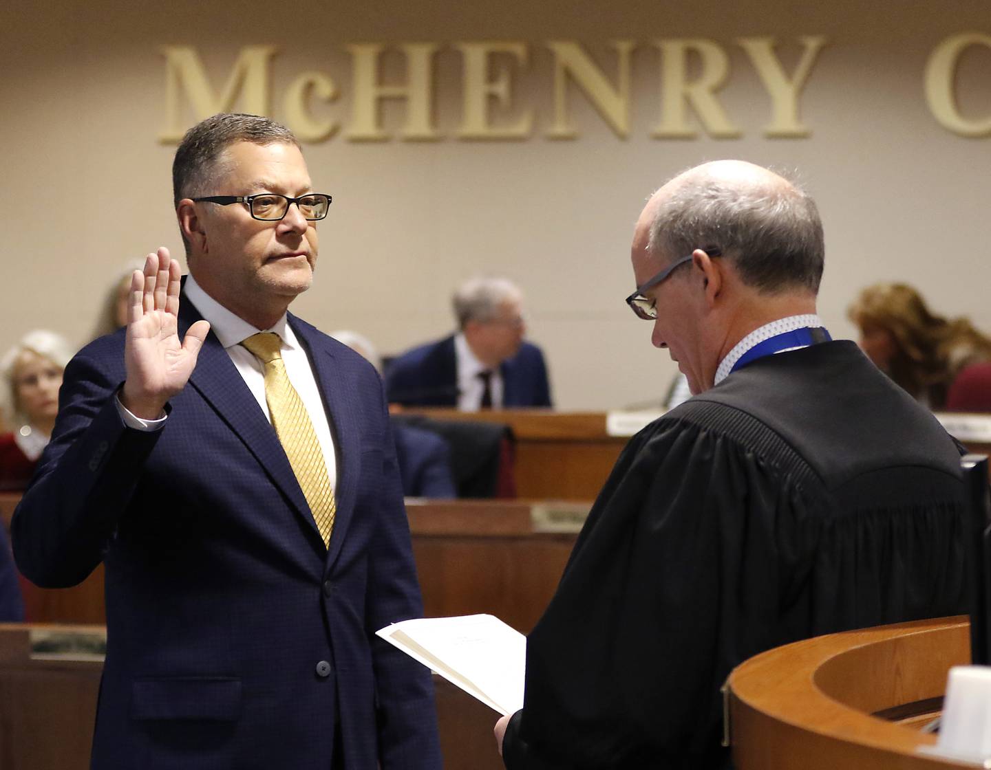 McHenry County Board Chair Mike Buehler takes the oath of office from Chief Judge Michael Feetterer on Monday, Dec. 2, 2024, at the McHenry County Administration Building in Woodstock.