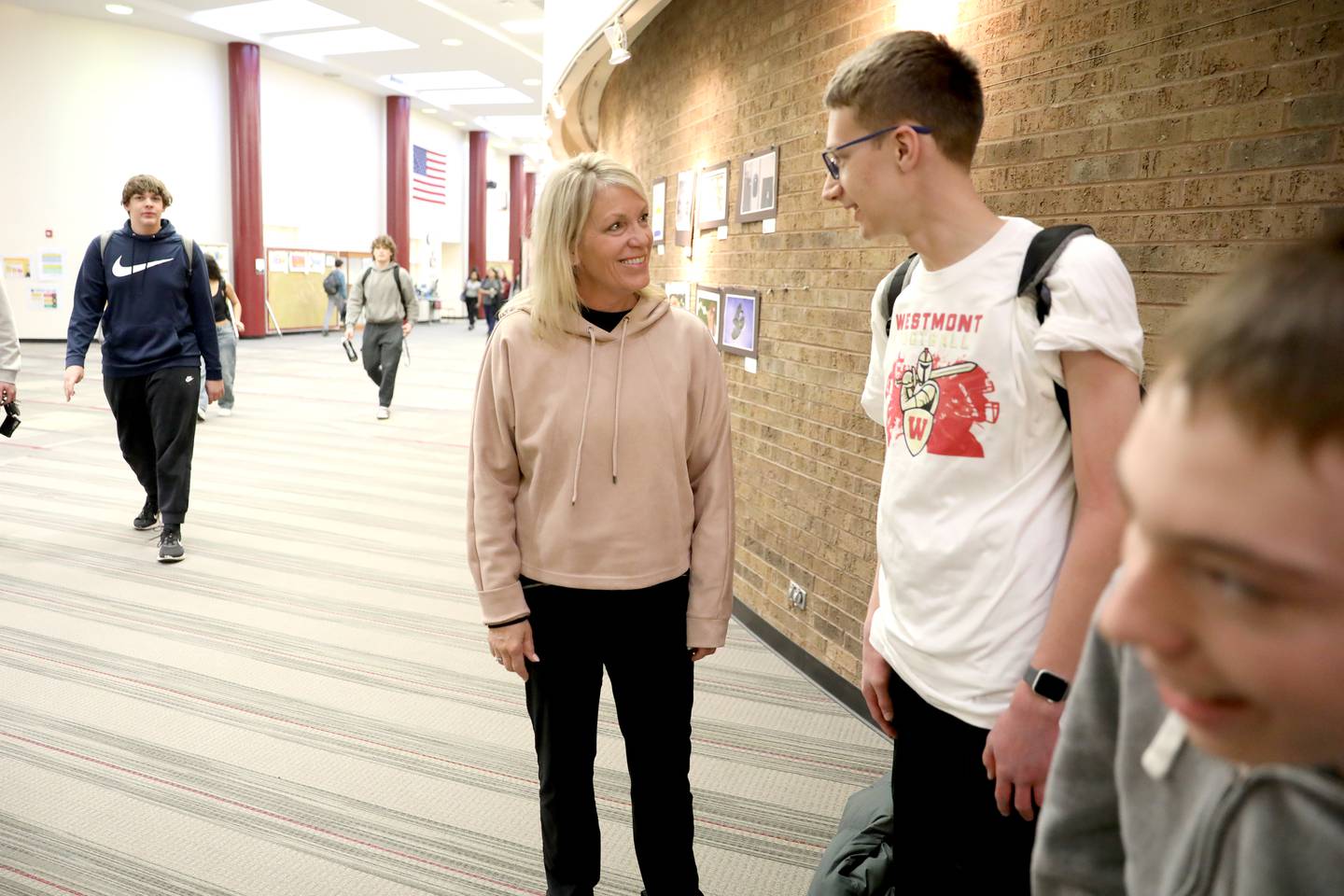 Leann Philgren, a special education teacher and track and field coach at Westmont High School, talks to students Joey McCullough and Ben Munsie.