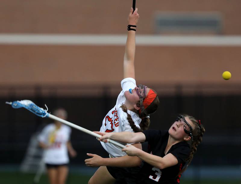 Crystal Lake Central co-op's Anna Starr and Huntley's Addyson Wasielewski battle for the bal during a Fox Valley Conference girls lacrosse match on Friday, April 17, 2026, at Crystal Lake Central High School.