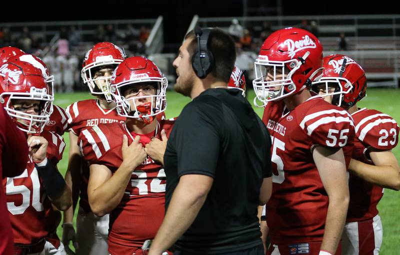 Hall High School football coach Logan Larson talks to his team while playing Kewanee on Friday, Sept. 27, 2024 at Richard Nesti Stadium.
