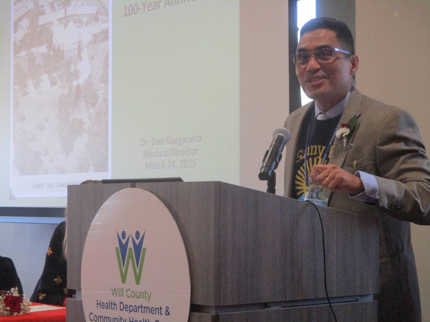 Dr. Dan Garganera, medical director for the Sunny Hill Tuberculosis Clinic, speaks at an event on Monday marking the 100th year for the clinic in Joliet. March 24, 2025