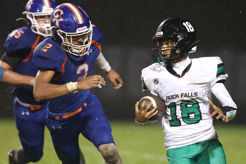 Rock Falls' Michael Flowers carries the ball with Genoa-Kingston's Tyler Atterberry and Ryan Swider in pursuit during their game Friday, Oct. 13, 2023, at Genoa-Kingston High School.