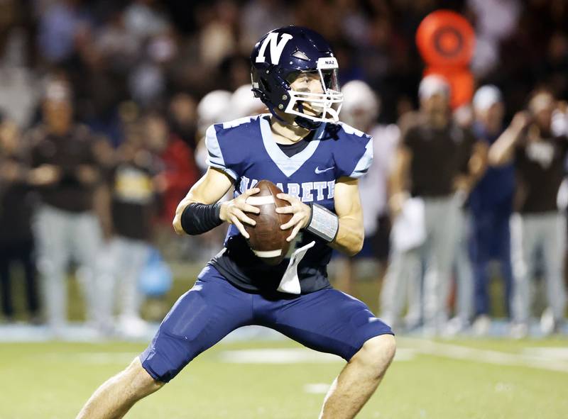 Nazareth's Frankie Nichols (4) drops back to pass during the varsity football game between Mt. Carmel high school and Nazareth Academy on Friday, Sept. 12, 2025 in La Grange Park, IL.