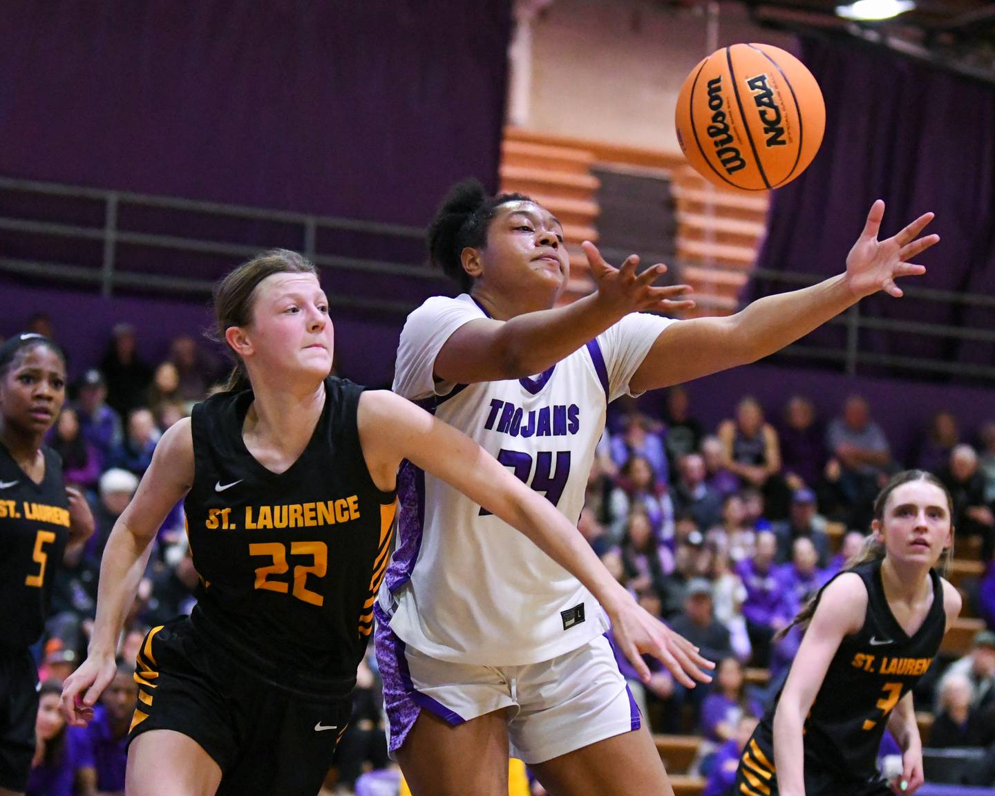Downers Grove North's Elizabeth Murphy (34) and St. Laurence's Sara Burzycki (22) battle for a loose ball on Thursday Feb. 19, 2026, during the 4A regional championship game held at Downers Grove North High School.