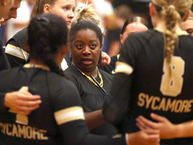 Sycamore head coach Jennifer Charles talks to her team during a timeout in their match against Genoa-Kingston Monday, Aug. 28, 2023, at Sycamore High School.