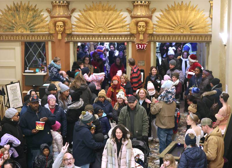 Attendees make their way inside after the Egyptian Theatre after Santa’s arrival Thursday, Dec. 4, 2025, during the annual Lights on Lincoln and Santa Comes to Town event hosted by the DeKalb Chamber of Commerce.