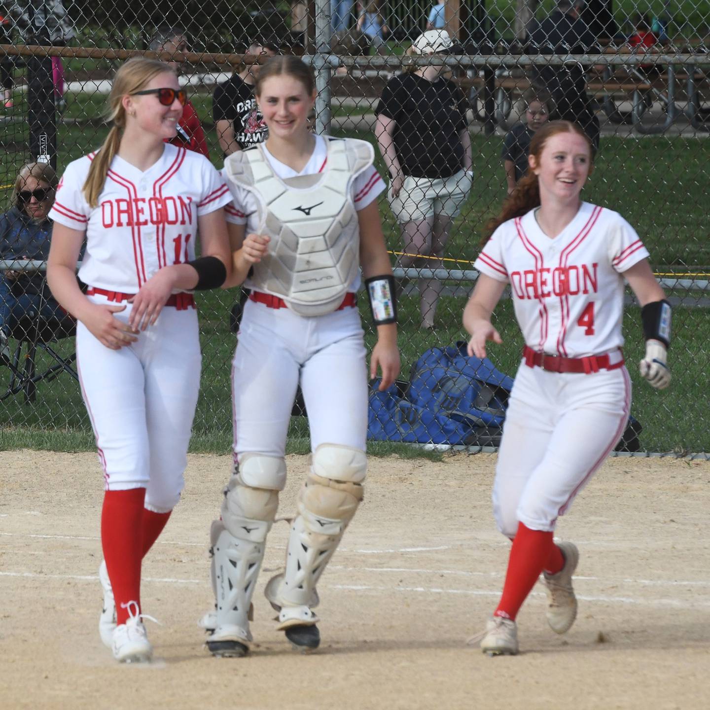 Oregon's Izzy Berg, Kendall Boyle, and Ashlee Mundell walk back to their dugout after beating Somonauk 6-0 at the 2A Oregon Regional on Wednesday, May 20, 2026.