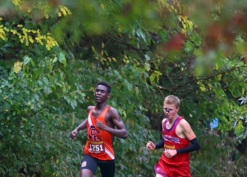 Crystal Lake Central’s Amana Omale, left, and Dundee-Crown’s Logan Grey compete during the Fox Valley Conference Cross Country Meet at McHenry County College in Crystal Lake on Saturday, October. 18, 2025.