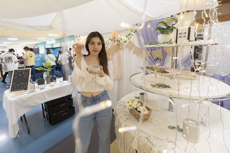 Rock Falls high School’s Gracie Rippy talks about her business Smellie Jellies, a gel based aroma enhancer Wednesday, April 26, 2023 at the trade show..