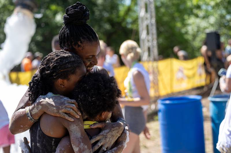 (top to bottom) Mother Janasha Eakins hugs Iman Eakins and Milan Eakins after finishing the 2025 Muddy Dash on Saturday, June 28, 2025 at Fox Valley Off Road in Utica.