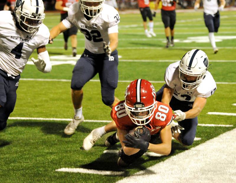 Yorkville receiver Colton Spychalski (80 attempts to get out-of-bounds against New Trier defenders, to stop the clock during a varsity football game at Yorkville High School on Friday, Sep. 1, 2023.