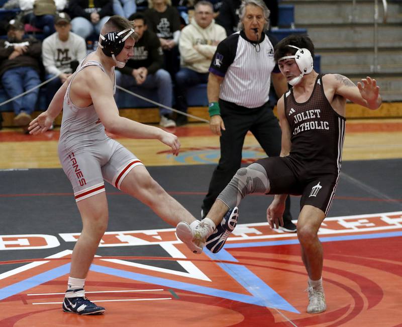 Marian Central's Jimmy Mastny tries to fend off Joliet Catholic's Issac Clauson in their 190-pound match during a triangle wrestling meet on Saturday Jan. 11, 2025, between Marian Central, Joliet Catholic, and Mt. Carmel at Marian Central High School in Woodstock.