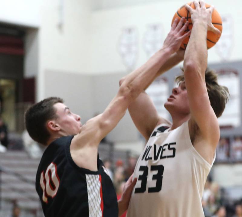 Prairie Ridge's Maddon McKim (right) shoots the ball over Huntley's Brady Hassels during a Fox Valley Conference boys basketball game on Wednesday, Jan. 21, 2026, at Prairie Ridge High School in Crystal Lake.
