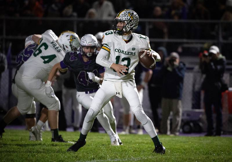 Coal City's Connor Henline drops back to pass in a game against Wilmington on Friday, October 24, 2025.