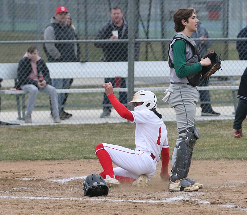 Ottawa's Julian Alexander scores the teams first run as St. Bede's catcher Nathan Husser watches the play on Wednesday, March 22, 2023 at Ottawa High School.