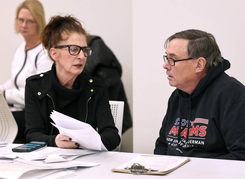 DeKalb City Council Ward 5 alderman Scott McAdams talks to his attorney Anna Wilhelmi Friday, Jan. 13, 2023, during a City of DeKalb Electoral Board hearing. The hearing was held to decide if McAdams, who is running unopposed for DeKalb’s 5th Ward aldermanic seat, should be removed from the ballot due to objections filed by two residents regarding signatures and filing procedure.