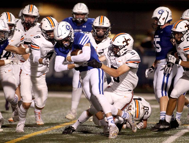 Geneva's Carter Powelson is taken down by St. Charles East's Michael Fulkerson during a game at Geneva on Friday, Oct. 1, 2021.