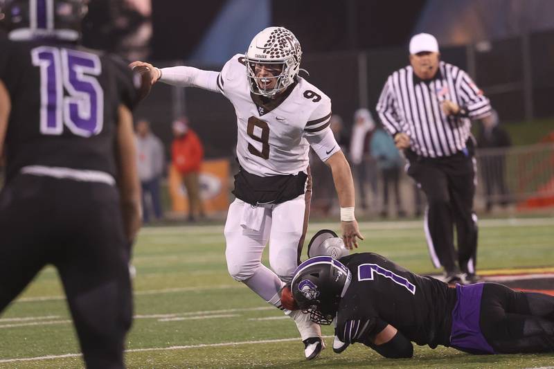 Mt. Carmel’s Jack Elliott evades Downers Grove North’s Cael Brezina in the Class 7A championship on Saturday, Nov. 25, 2023 at Hancock Stadium in Normal.