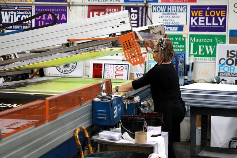 Beatrice Perez of Awesome Campaigns Inc. in Elgin works on printing campaign signs.