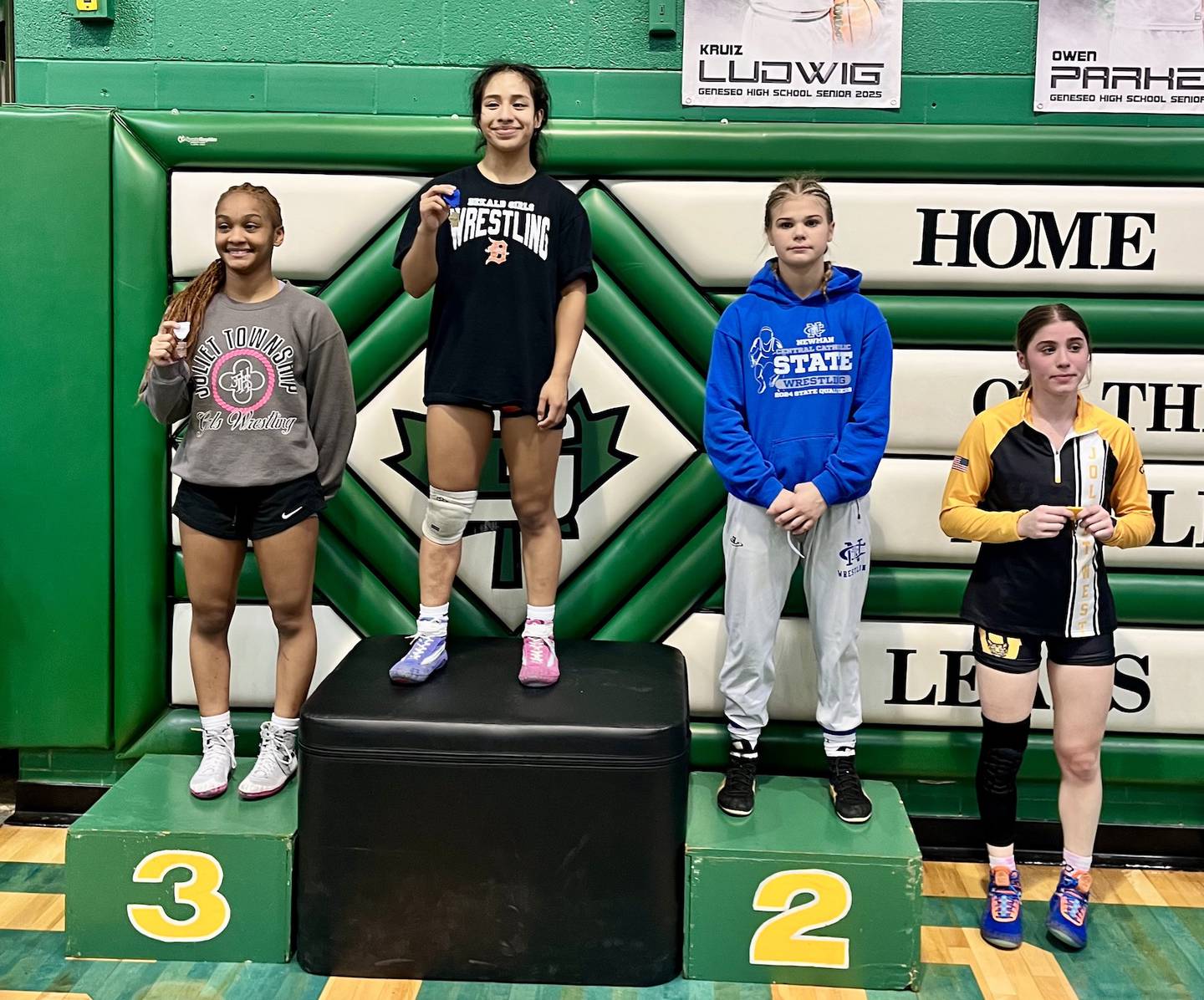 DeKalb's Alex Gregorio-Perez stands atop the podium after winning the 105-pound title at the Geneseo Sectional on Saturday, Feb. 15, 2025.