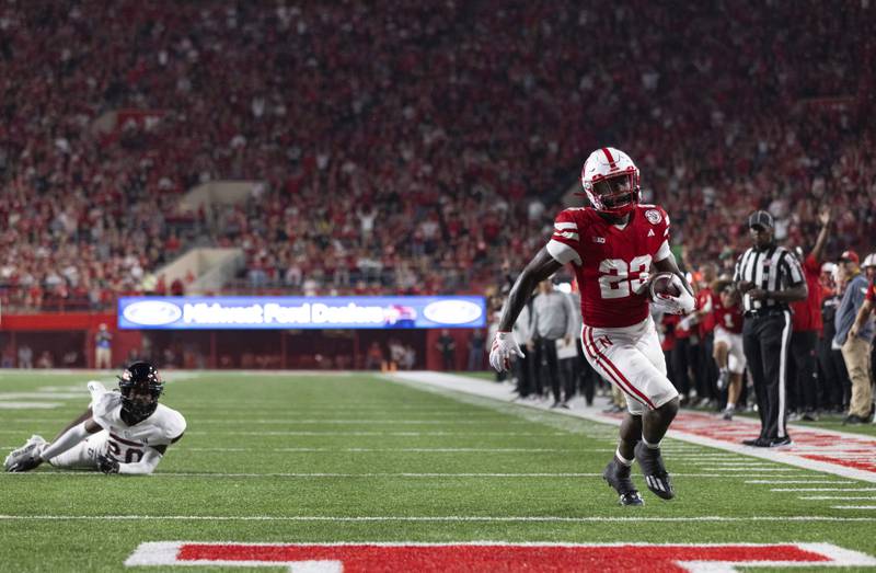 Nebraska's Anthony Grant (23) runs in a touchdown against Northern Illinois' Jacob Finley (20) during the second half of an NCAA college football game, Saturday, Sept. 16, 2023, in Lincoln, Neb. (AP Photo/Rebecca S. Gratz)