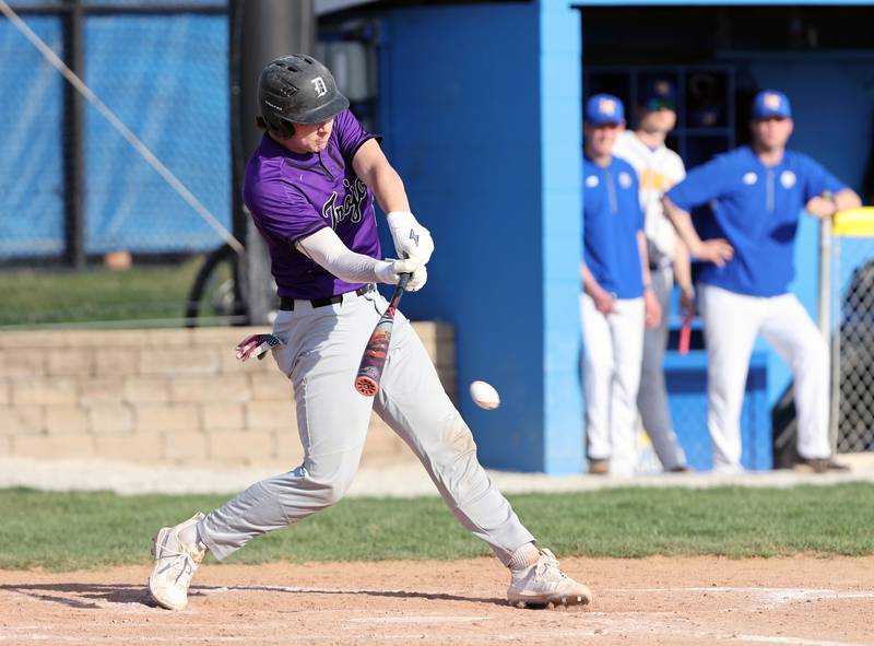 Downers Grove North's Jimmy Janicki (16) makes contact with the ball during the boys varsity baseball game between Lyons Township and Downers Grove North high schools in Western Springs on Tuesday, April 11, 2023.