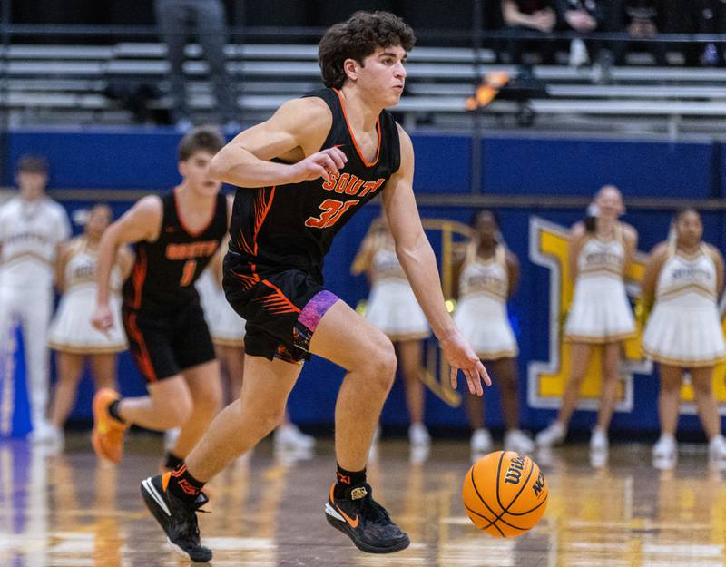 Wheaton Warrenville South’s Luca Carbonaro brings the ball up court during a game against Wheaton North on Friday, Dec. 20, 2024.