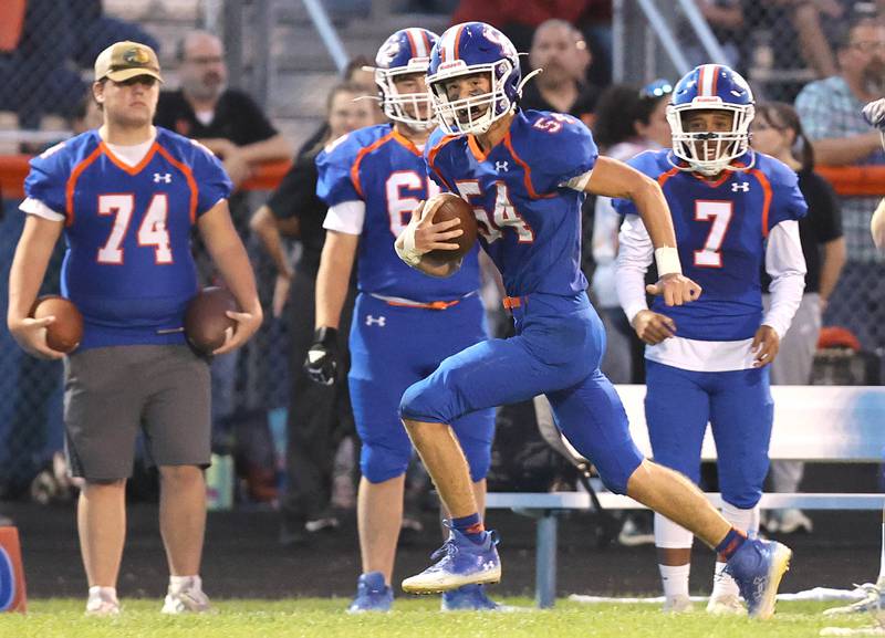 Genoa-Kingston's Connor Grimm scoops up a fumble and returns it for a touchdown during their game against North Boone Friday, Sept. 9, 2022, at Genoa-Kingston High School.