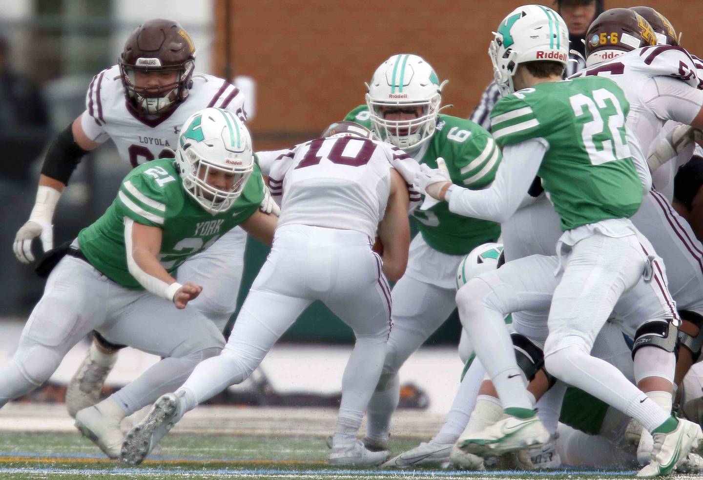 Loyola's Danny Herbert (10) moves upfield as York’s Cole Ostendorf (21)  David Loch (6) and Jack Korzeniowski (22) converge on him during the IHSA Class 8A semifinal football game Saturday November 19, 2022 in Elmhurst.