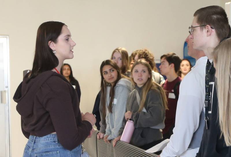 L-P High School student Emma Gochanour (left) leads a group of Naperville Central students to the swimming pool in the East gym building on Tuesday, April 18, 2023 at L-P High School. L-P students led tours showing the Naperville Central students different parts of the campus.