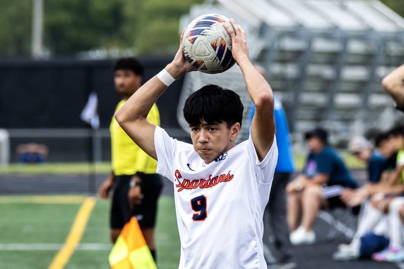 Romeoville's Diego Garcia throws in during a varsity soccer away game against Minooka on Sept. 23, 2025.