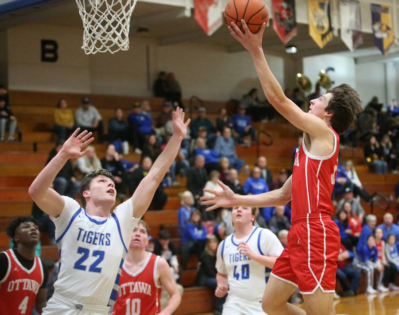 Ottawa's Huston Hart drives to the hoop as Princeton's Evan Driscoll on Monday, Feb. 5, 2024 at Prouty Gym.