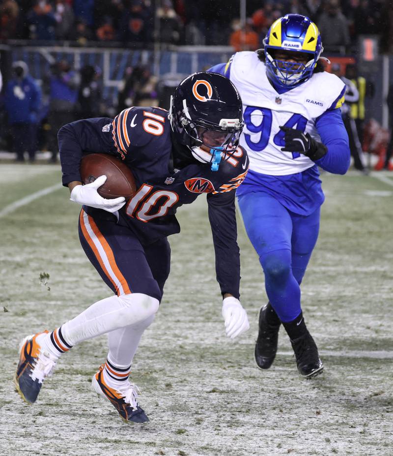 Chicago Bears wide receiver Luther Burden III outruns Los Angeles Rams defensive end Desjuan Johnson Sunday, Jan. 18, 2026, during their NFC divisional playoff matchup at Soldier Field in Chicago.
