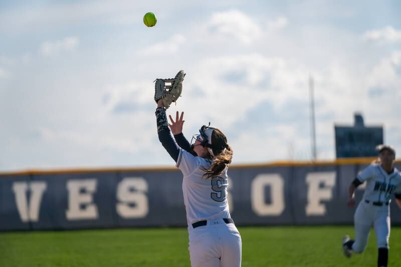 Oswego East's Kenzie Gatz (9) catches an infield pop-up for an out against Oswego during a softball game at Oswego East High School on Friday, April 21, 2023.
