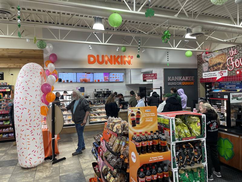 Dunkin' customers line up to spin a prize wheel Feb. 28, 2025, during a grand opening celebration for the newly remodeled location inside of Gas and Wash on Court Street in Kankakee. The first 100 customers received a coupon book for free coffee.