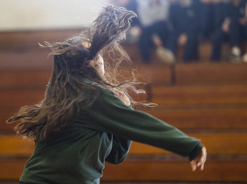 Hair goes flying as a student follows through on a throw Monday, Jan. 26, 2026, during the Deanery Dodgeball tournament.