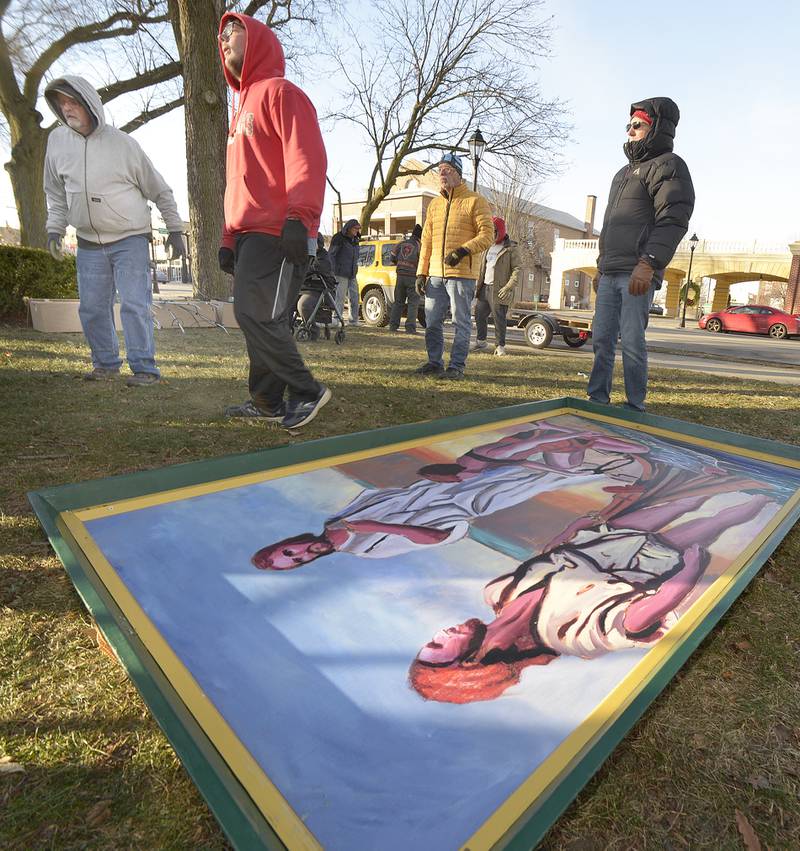 One of the 16 paintings depicting Jesus’ birth, life and ministry awaits to be erected Saturday in Ottawa’s Washington Square.