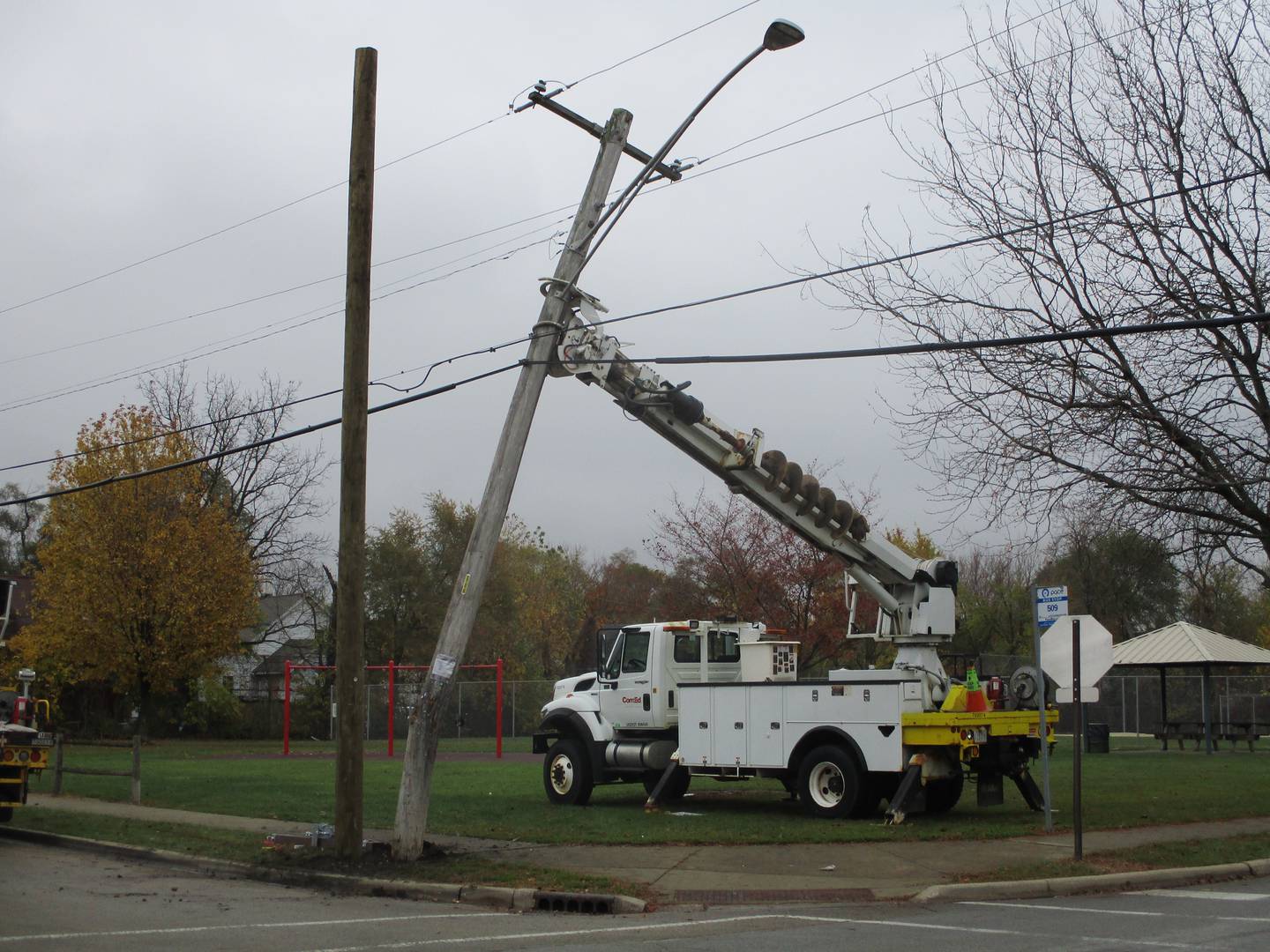 ComEd crews on Monday replace a pole damaged when a man was shot while driving and crashed into the pole at Desmond Park in Joliet where he died on Sunday. Oct. 31, 2022.