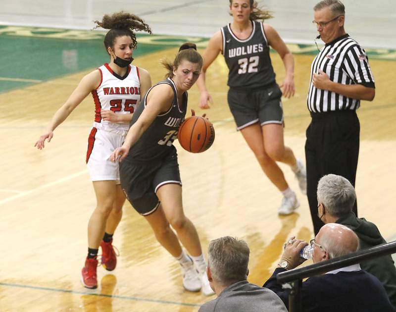 Prairie Ridge's Karsen Karlblomtries to keep inbounds as she bring the ball up the court against Deerfield's Lexi Kerstein during a IHSA Class 3A Grayslake Central Sectional semifinal basketball game Tuesday evening, Feb. 22, 2022, between Prairie Ridge and Deerfield at Grayslake Central High School.