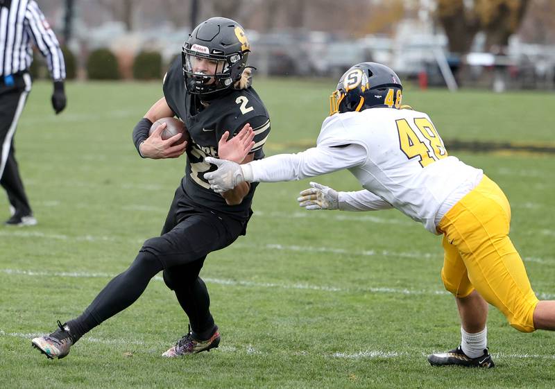 Sycamore's Elijah Meier fends off Sterling's Lance Wren on his way to a touchdown during their Class 5A state playoff game Saturday, Nov. 12, 2022, at Sycamore High School.