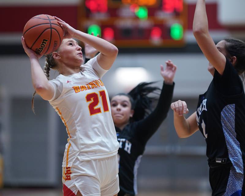 Batavia’s Kylee Gehrt (21) shoots the ball in the post against St. Charles North's Riley Barber (12) during a basketball game at Batavia High School on Tuesday, Dec 5, 2023.