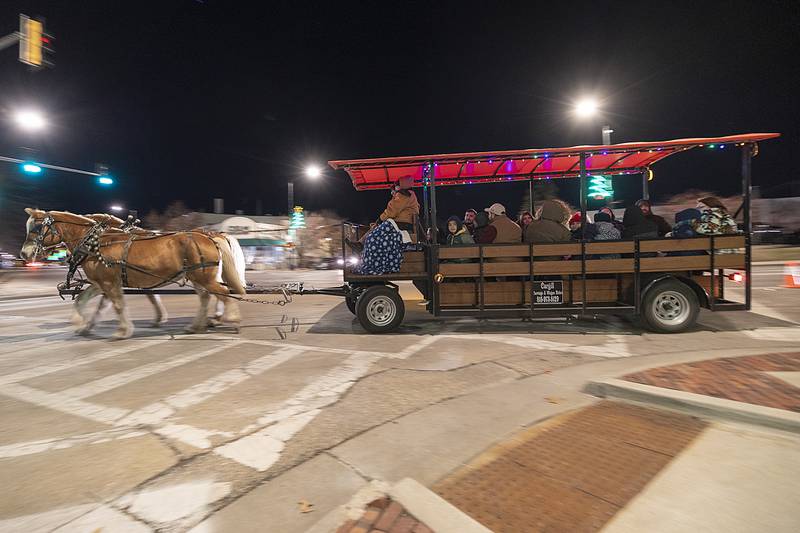 Riders take a tour of the downtown Friday, Dec. 6, 2024, on a horse drawn carriage during Sterling’s Sights and Sounds Christmas event.