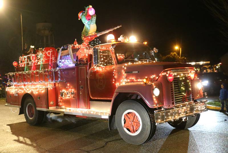 People ride in the back of a firetruck in the inaugural Lighted Christmas Parade on Friday, Dec. 1, 2023 in Princeton.