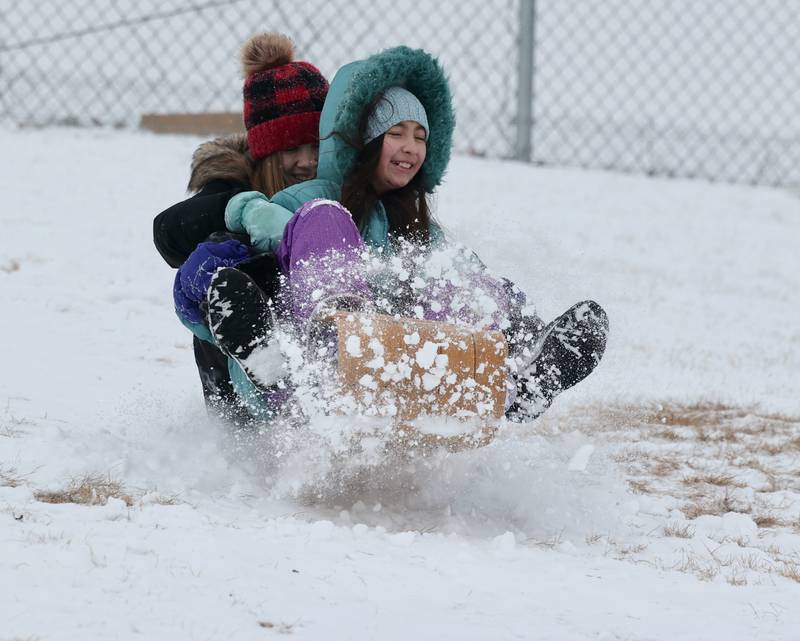 Molly Casiano, (front) 9, and Alex Schwantes, 15, both from DeKalb, enjoy the sled hill Wednesday, Feb. 12, 2025, at Hopkins Park in DeKalb.