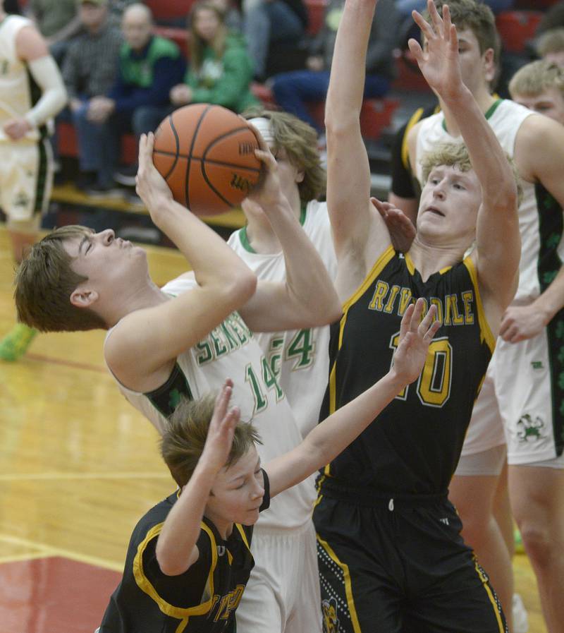 Seneca’s Cameron Shriey works to get a shot away as Riverdale’s Brody Clark attempts to block during the 2nd period Friday at Regional Championship at Hall.