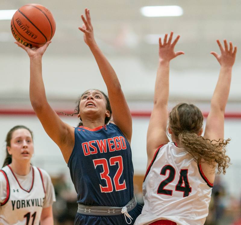 Oswego’s Ahlivia East (32) shoots the ball in the post against Yorkville's Ava Diqui (24) during the 13th annual Hoops 4 Hope Communities vs. Cancer basketball event at Yorkville High School on Saturday, Jan 28, 2023.