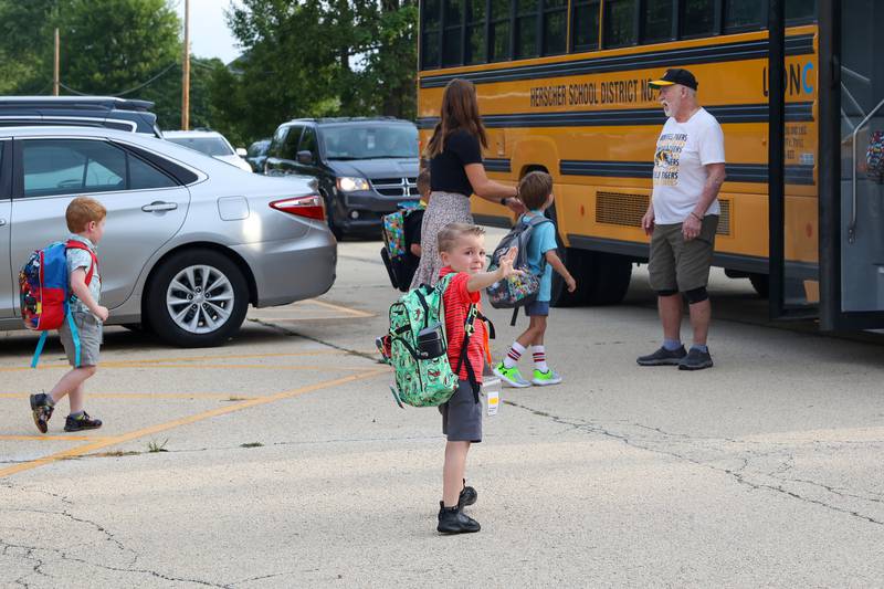 Finnegan Berns, 5, of Herscher, waves goodbye as he boards the school bus to Bonfield Grade for his first day of kindergarten on Tuesday, Aug. 19, 2025.